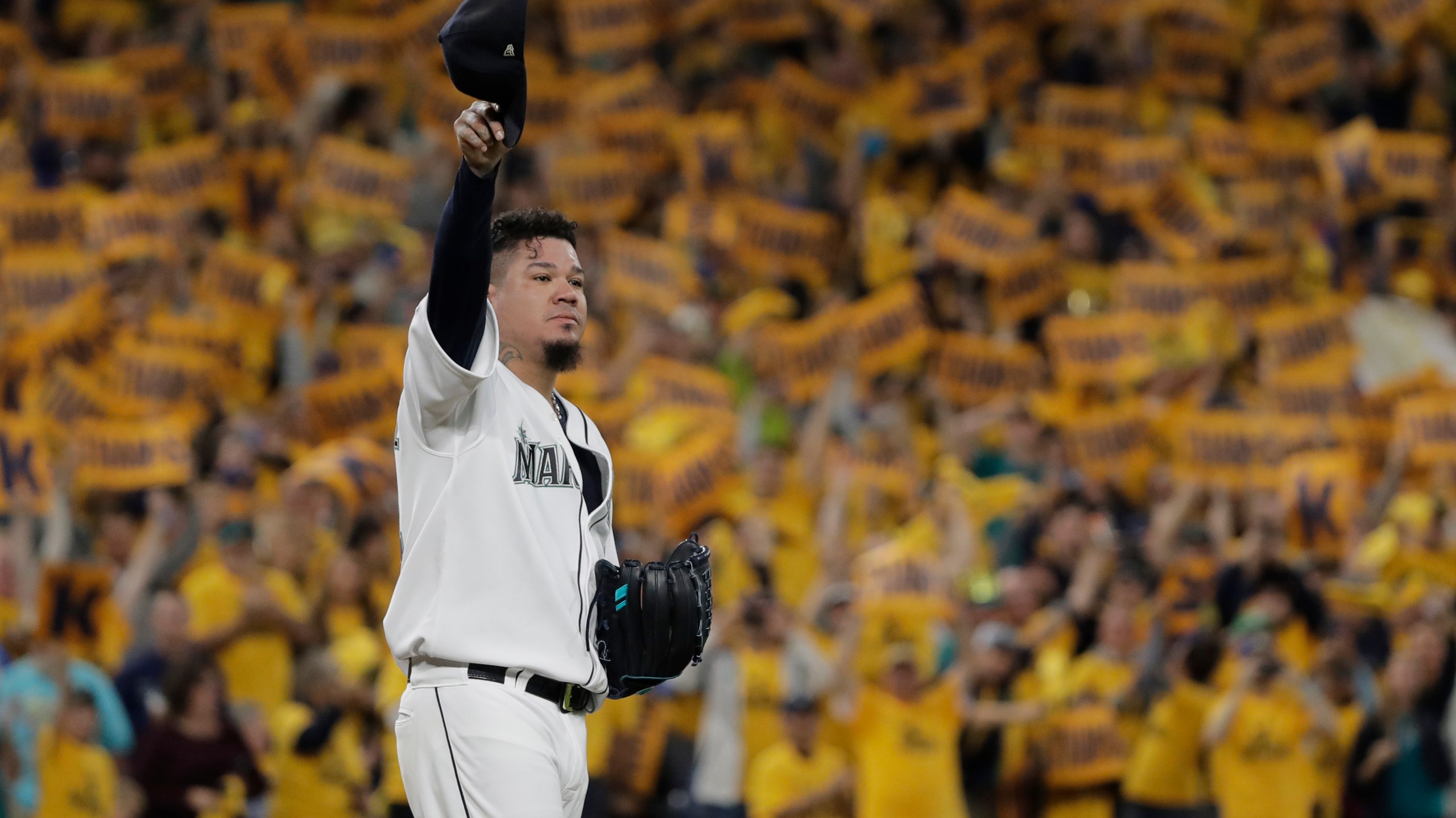 FILE - With the "King's Court" cheering section behind him, Seattle Mariners starting pitcher Félix Hernández tips his cap as he takes the mound for the team's baseball game against the Oakland Athletics, Sept. 26, 2019, in Seattle. (AP Photo/Ted S. Warren, File)