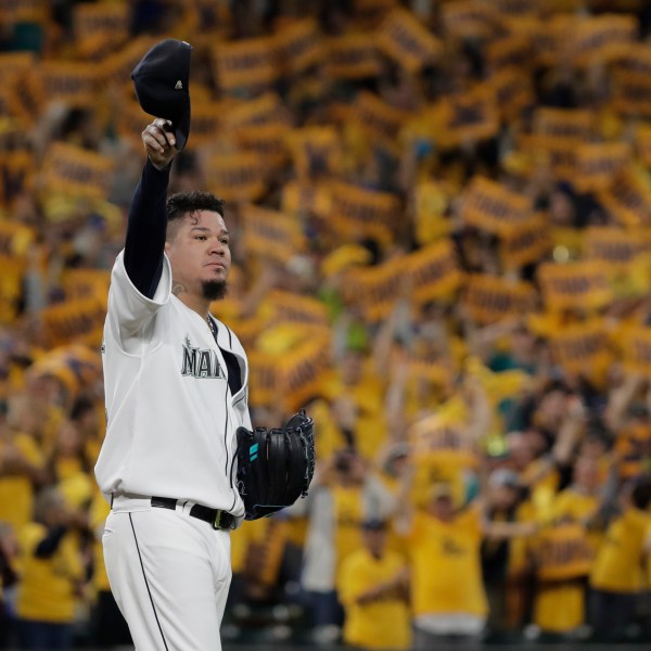 FILE - With the "King's Court" cheering section behind him, Seattle Mariners starting pitcher Félix Hernández tips his cap as he takes the mound for the team's baseball game against the Oakland Athletics, Sept. 26, 2019, in Seattle. (AP Photo/Ted S. Warren, File)