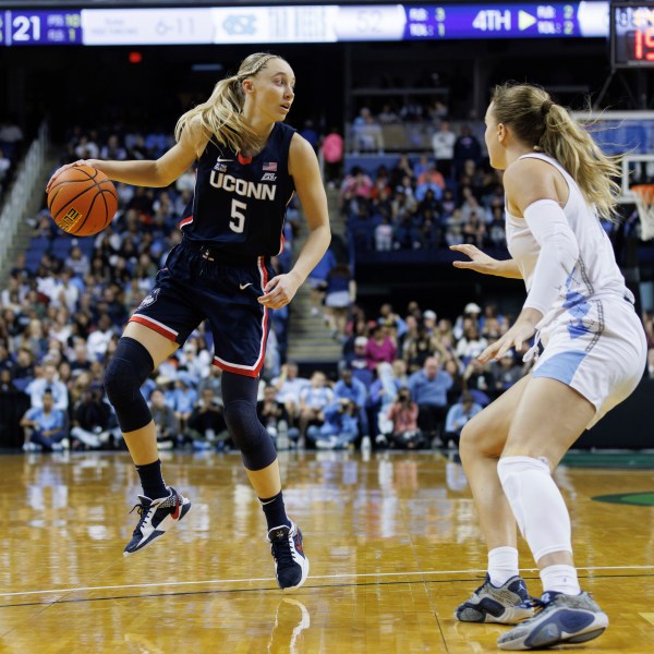 UConn's Paige Bueckers (5) handles the ball as North Carolina's Alyssa Ustby, right, defends during the second half of an NCAA college basketball game in Greensboro, N.C., Friday, Nov. 15, 2024. (AP Photo/Ben McKeown)