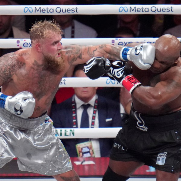 Jake Paul lands a left to Mike Tyson during their heavyweight boxing match, Friday, Nov. 15, 2024, in Arlington, Texas. (AP Photo/Julio Cortez)