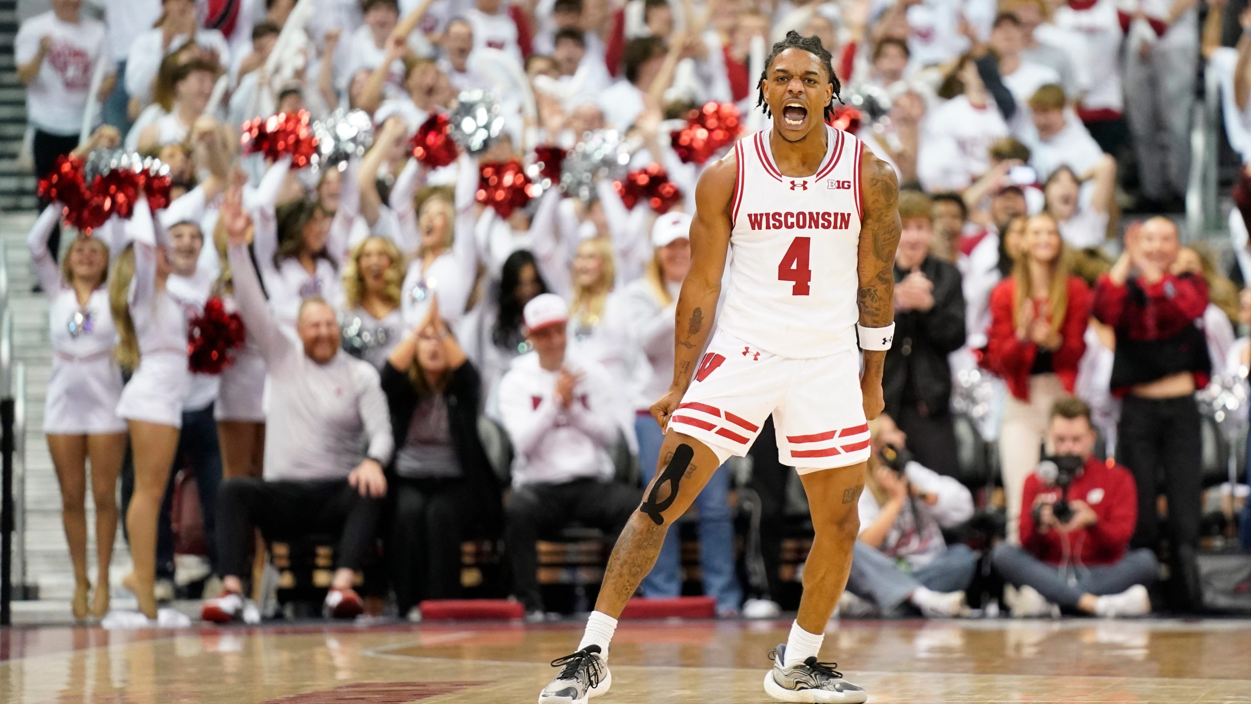 Wisconsin guard Kamari McGee (4) celebrates scoring a basket against Arizona during the second half of an NCAA college basketball game Friday, Nov. 15, 2024, at the Kohl Center in Madison, Wis. (AP Photo/Kayla Wolf)