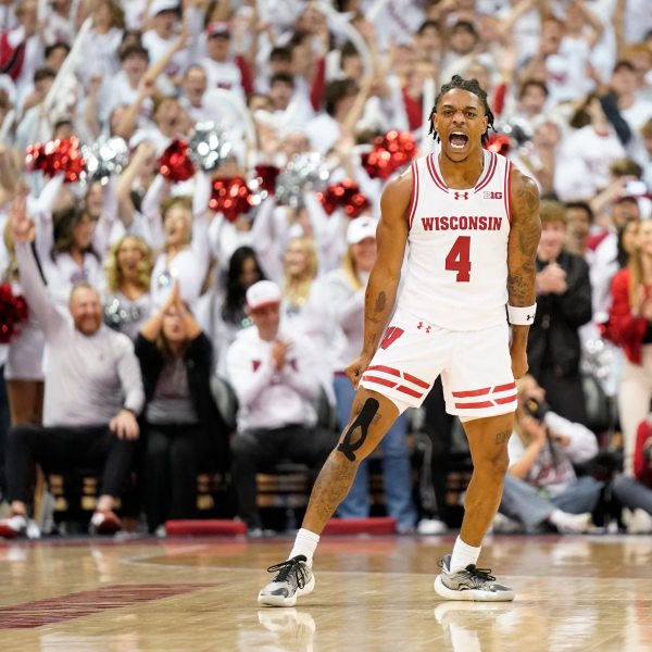 Wisconsin guard Kamari McGee (4) celebrates scoring a basket against Arizona during the second half of an NCAA college basketball game Friday, Nov. 15, 2024, at the Kohl Center in Madison, Wis. (AP Photo/Kayla Wolf)