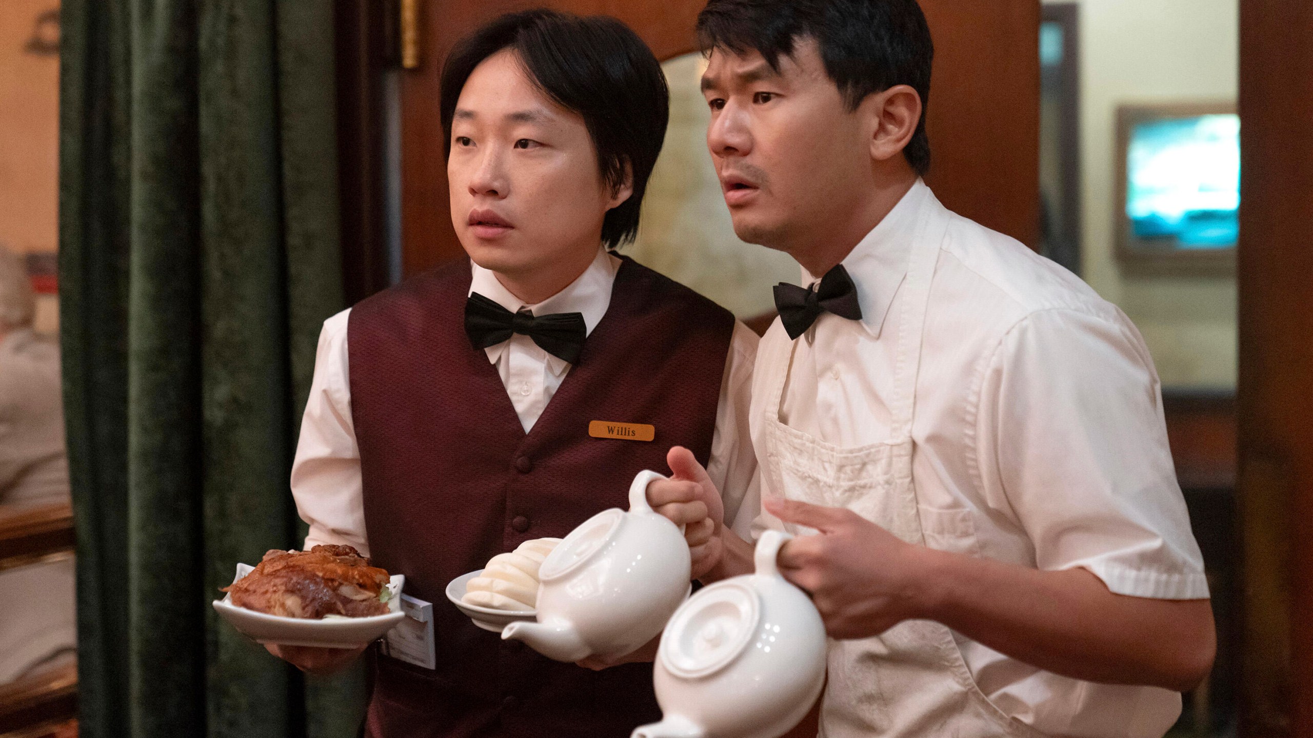 This image released by Hulu shows Jimmy O. Yang, left, and Ronny Chieng in a scene from the series "Interior Chinatown." (Mike Taing/Hulu via AP)