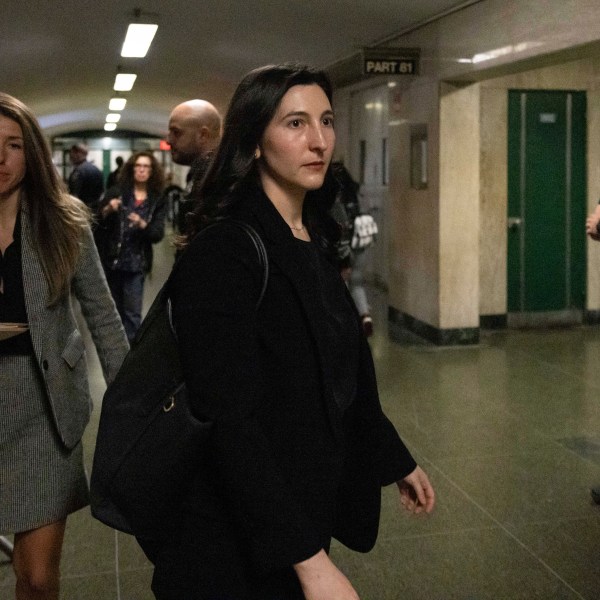 Dr. Cynthia Harris, forensic pathologist at the Office of the City Medical Examiner, leaves the courtroom for a lunch break in New York, Monday, Nov. 18, 2024. (AP Photo/Yuki Iwamura)