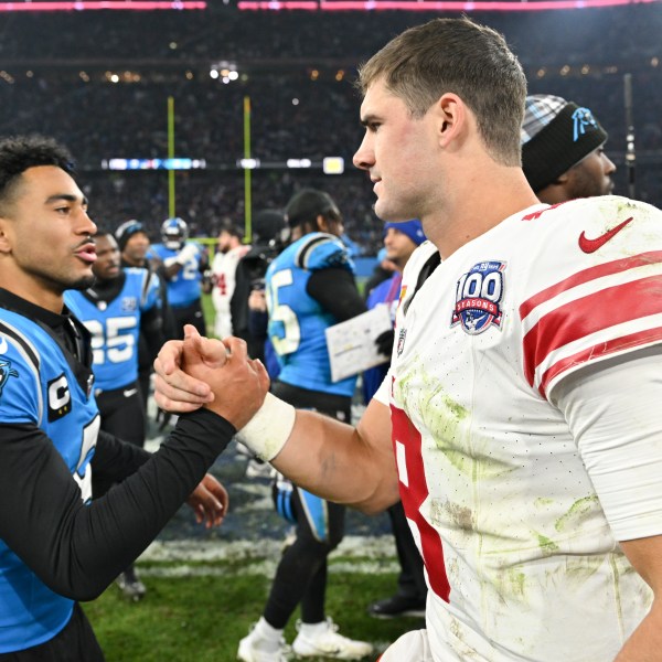 Carolina Panthers quarterback Bryce Young greets New York Giants quarterback Daniel Jones after their overtime win in an NFL football game, Sunday, Nov. 10, 2024, in Munich, Germany. (AP Photo/Lennart Preiss)