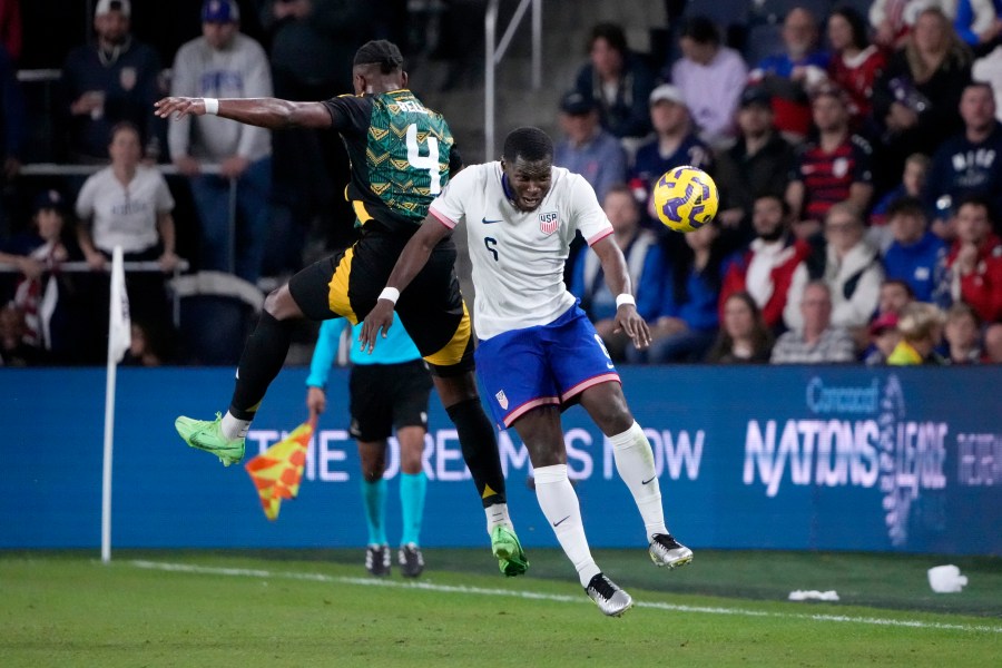 United States' Yunus Musah (6) and Jamaica's Amari'i Bell (4) battle for the ball during the first half in a CONCACAF Nations League quarterfinal second leg soccer match Monday, Nov. 18, 2024, in St. Louis. (AP Photo/Jeff Roberson)