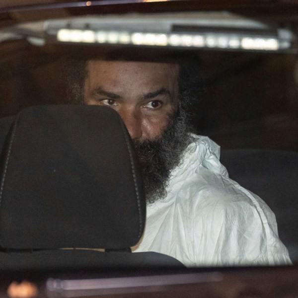 Ramon Rivera, a suspect arrested after multiple people were stabbed early Monday, is escorted out by NYPD officers at the NYPD 10th Precinct in New York, Monday, Nov. 18, 2024. (AP Photo/Yuki Iwamura)