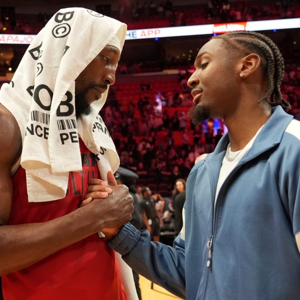 Miami Heat center Bam Adebayo, left, shakes shakes with Philadelphia 76ers guard Tyrese Maxey, right, after an NBA basketball game, Monday, Nov. 18, 2024, in Miami. (AP Photo/Lynne Sladky)