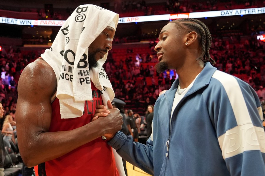 Miami Heat center Bam Adebayo, left, shakes shakes with Philadelphia 76ers guard Tyrese Maxey, right, after an NBA basketball game, Monday, Nov. 18, 2024, in Miami. (AP Photo/Lynne Sladky)