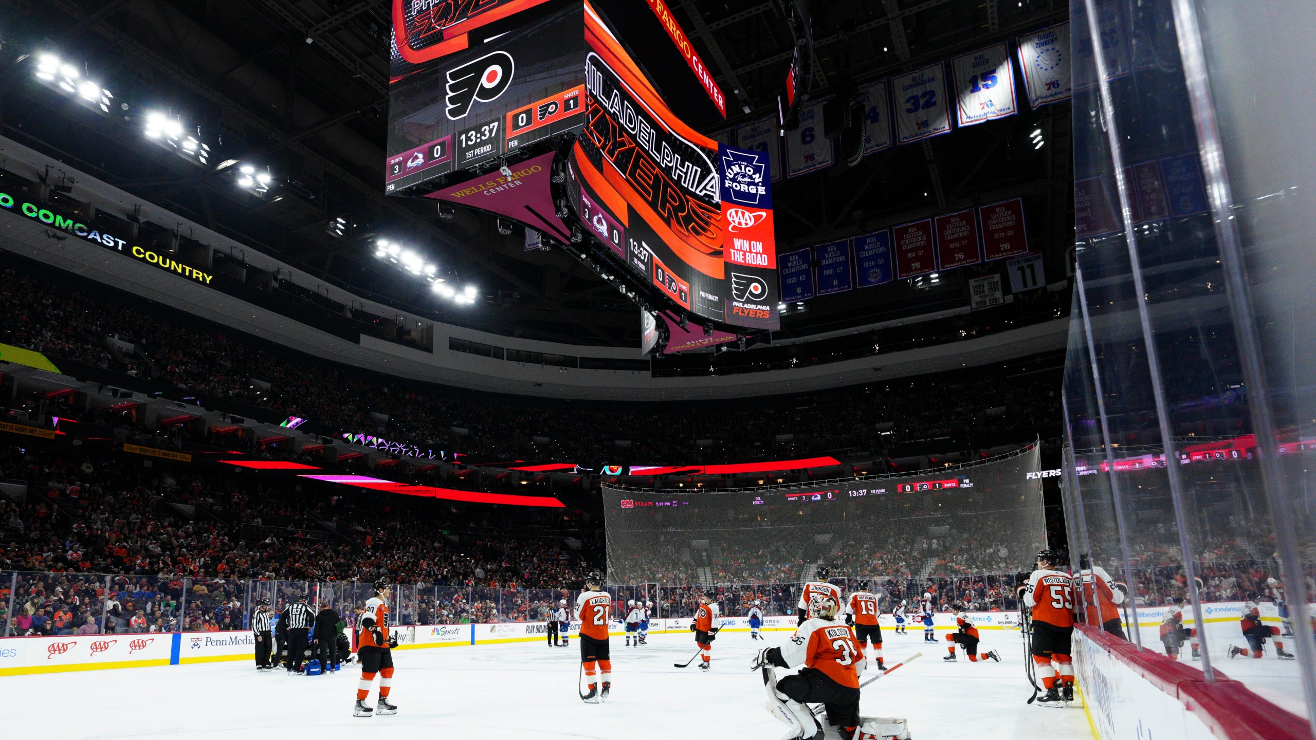 Referee Mitch Dunning, bottom left, lies on the ice after an injury during the first period of an NHL hockey game between the Philadelphia Flyers and the Colorado Avalanche, Monday, Nov. 18, 2024, in Philadelphia. (AP Photo/Derik Hamilton)