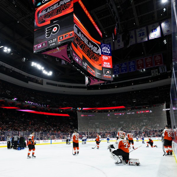 Referee Mitch Dunning, bottom left, lies on the ice after an injury during the first period of an NHL hockey game between the Philadelphia Flyers and the Colorado Avalanche, Monday, Nov. 18, 2024, in Philadelphia. (AP Photo/Derik Hamilton)