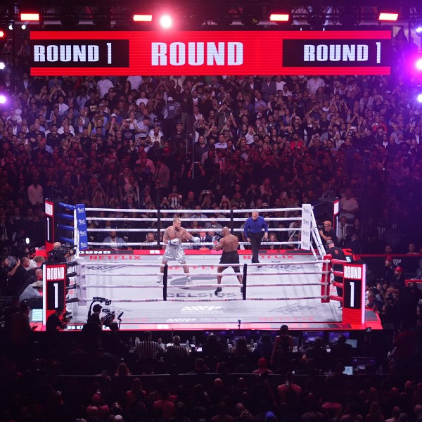 Jake Paul, left, and Mike Tyson fight during their heavyweight boxing match, Friday, Nov. 15, 2024, in Arlington, Texas. (AP Photo/Julio Cortez)