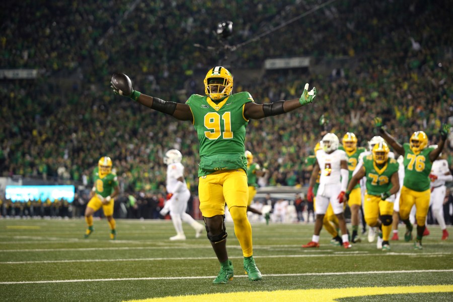 Oregon offensive lineman Gernorris Wilson (91) celebrates his touchdown reception during an NCAA college football game against Maryland, Saturday, Nov. 9, 2024, in Eugene, Ore. (AP Photo/Lydia Ely)