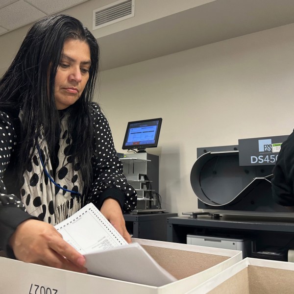 Jessica Cabrera works with a stack of ballots during a state-mandated recount of the U.S. Senate race at the Lehigh County Government Center in Allentown, Pa., Tuesday, Nov. 19, 2024. (AP Photo/Michael Rubinkam)