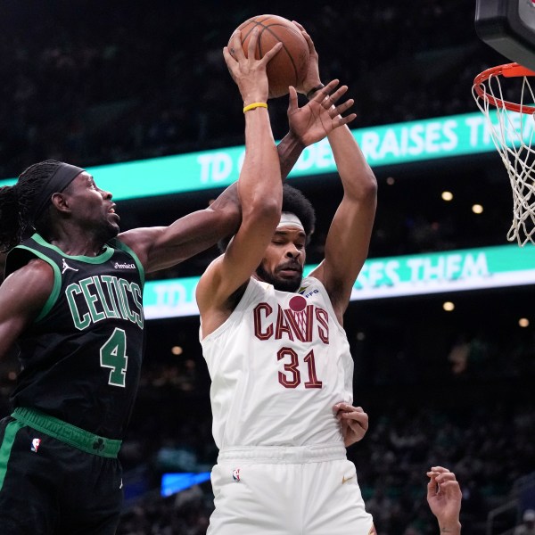 Boston Celtics guard Jrue Holiday (4) battles for a rebound against Cleveland Cavaliers center Jarrett Allen (31) during the first half of an Emirates NBA Cup basketball game, Tuesday, Nov. 19, 2024, in Boston. (AP Photo/Charles Krupa)