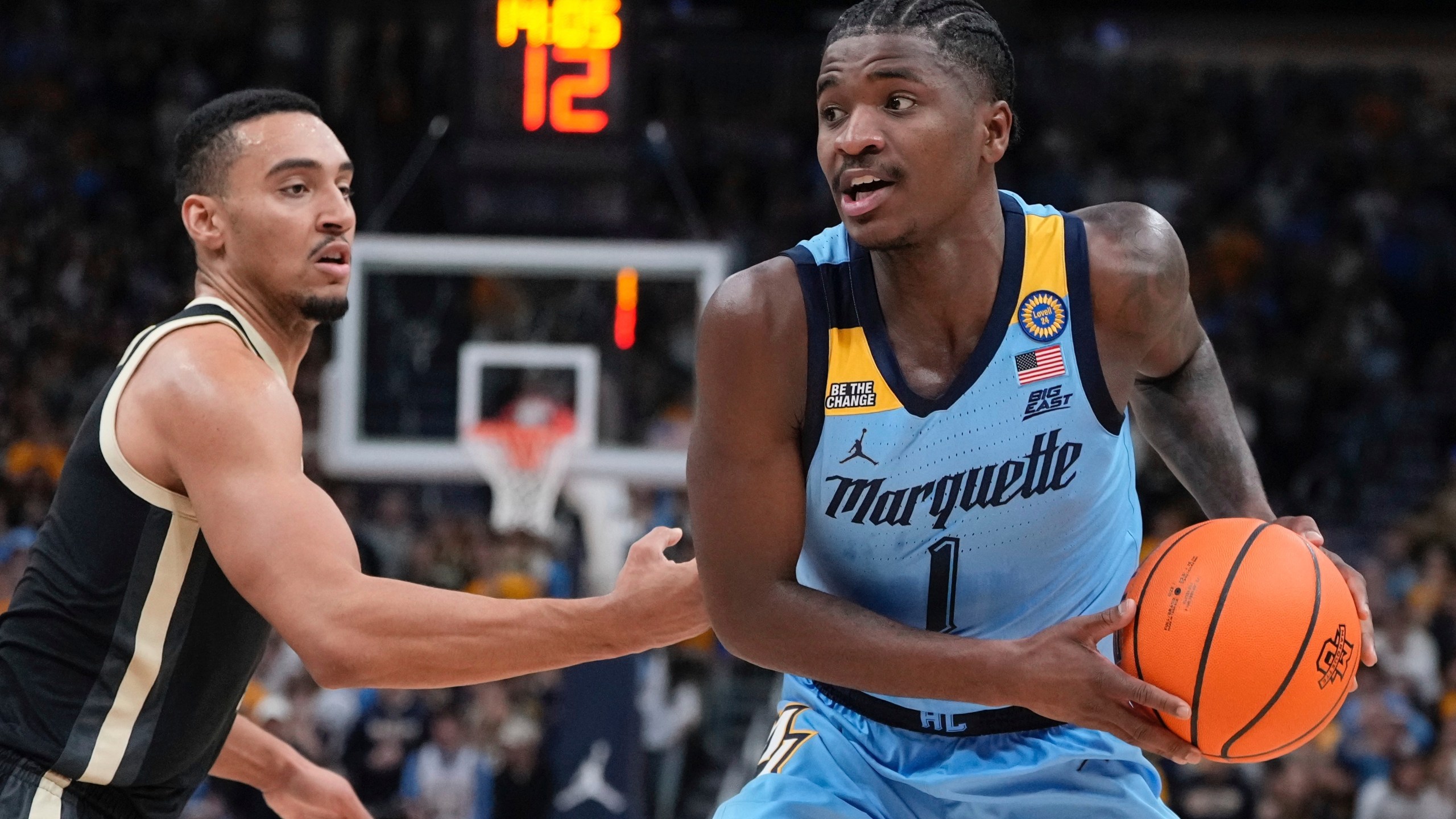 Marquette's Kam Jones tries to get past Purdue's Trey Kaufman-Renn during the first half of an NCAA college basketball game Tuesday, Nov. 19, 2024, in Milwaukee. (AP Photo/Morry Gash)