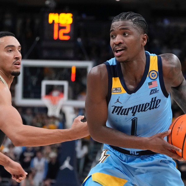 Marquette's Kam Jones tries to get past Purdue's Trey Kaufman-Renn during the first half of an NCAA college basketball game Tuesday, Nov. 19, 2024, in Milwaukee. (AP Photo/Morry Gash)