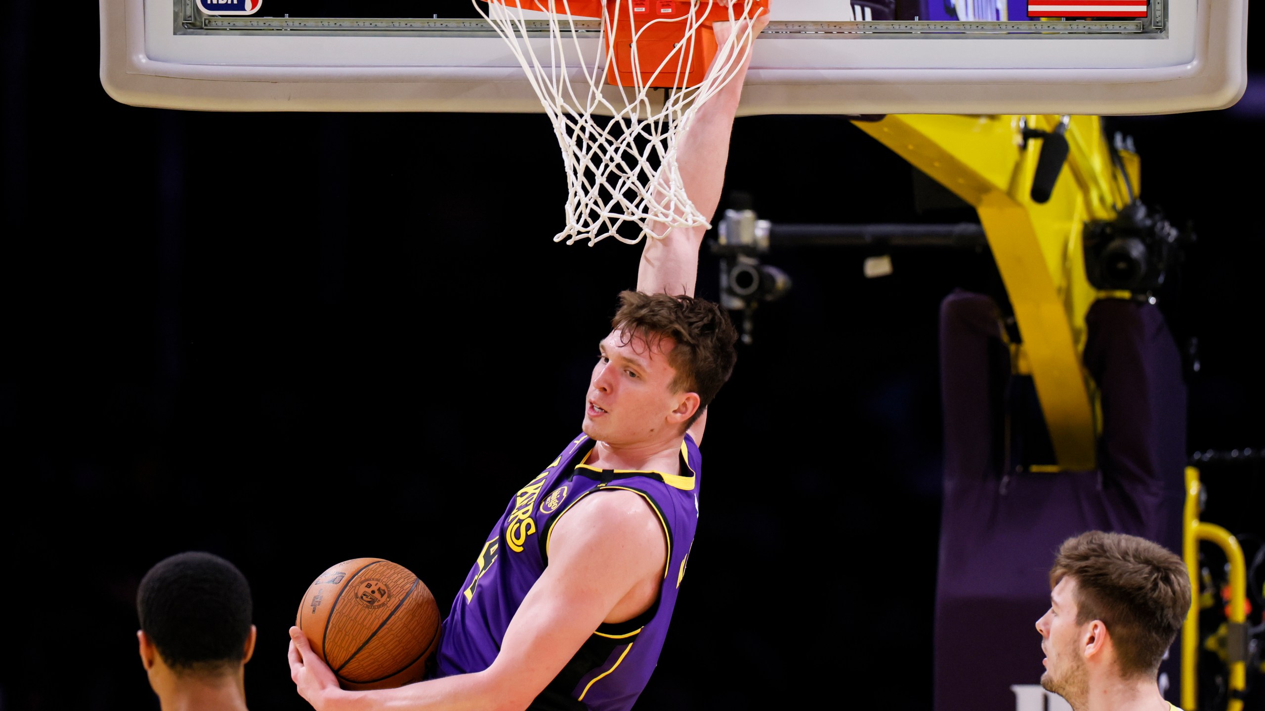 Los Angeles Lakers guard Dalton Knecht dunks during the first half of an Emirates NBA Cup basketball game agaianst the Utah Jazz, Tuesday, Nov. 19, 2024, in Los Angeles. (AP Photo/Etienne Laurent)