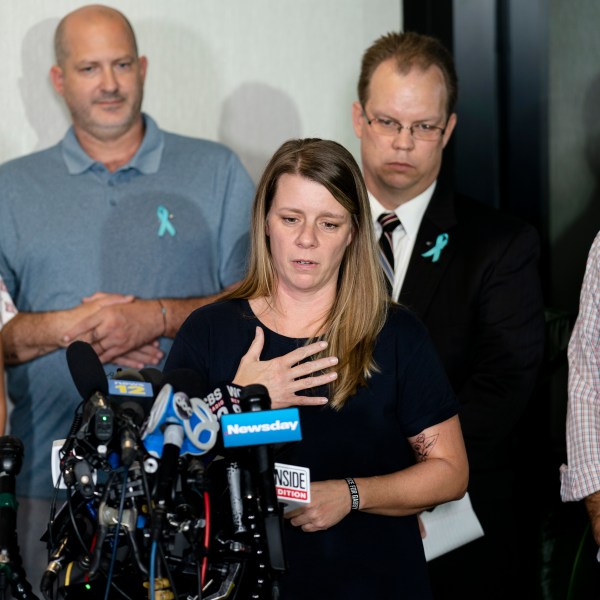 FILE - Nichole Schmidt, mother of Gabby Petito, whose death on a cross-country trip has sparked a manhunt for her boyfriend Brian Laundrie, speaks alongside, from left, Tara Petito, stepmother, Joseph Petito, father, Richard Stafford, family attorney, and Jim Schmidt, stepfather, during a news conference, Sept. 28, 2021, in Bohemia, N.Y. (AP Photo/John Minchillo, File)