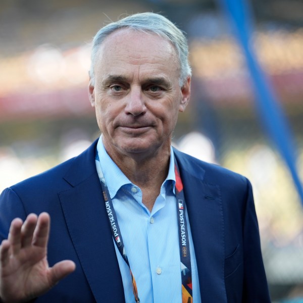 Commissioner of Major League Baseball, Rob Manfred walks on the field before Game 2 of the baseball World Series between the Los Angeles Dodgers and the New York Yankees, Saturday, Oct. 26, 2024, in Los Angeles. (AP Photo/Ashley Landis)