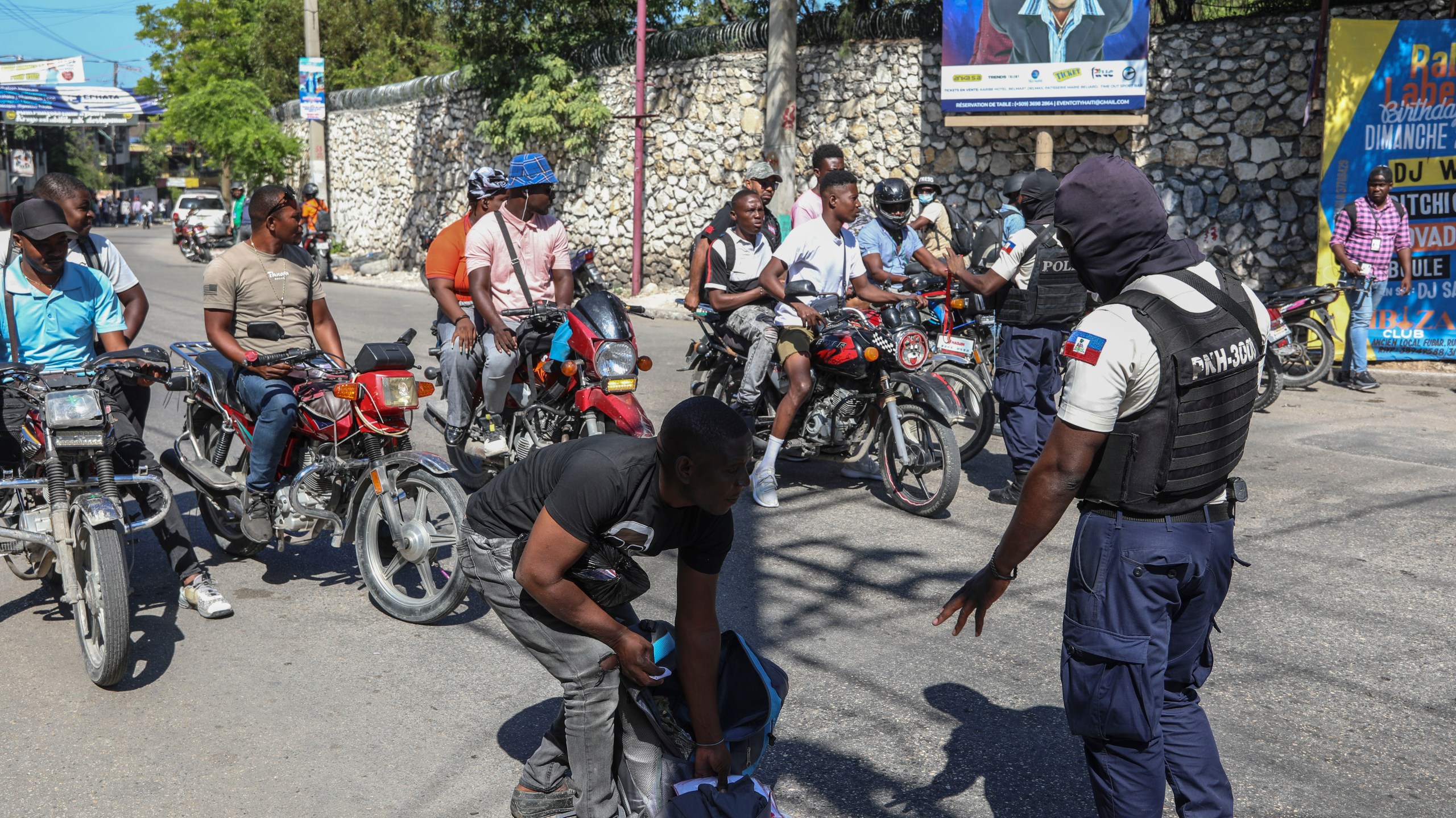 Police officers man a checkpoint checking for weapons, in the Petion-Ville of Port-au-Prince, Haiti, Tuesday, Nov. 19, 2024. (AP Photo/Odelyn Joseph)