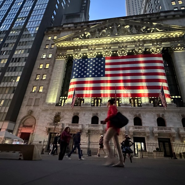 FILE - People pass the New York Stock Exchange on Nov. 5, 2024, in New York. (AP Photo/Peter Morgan, File)