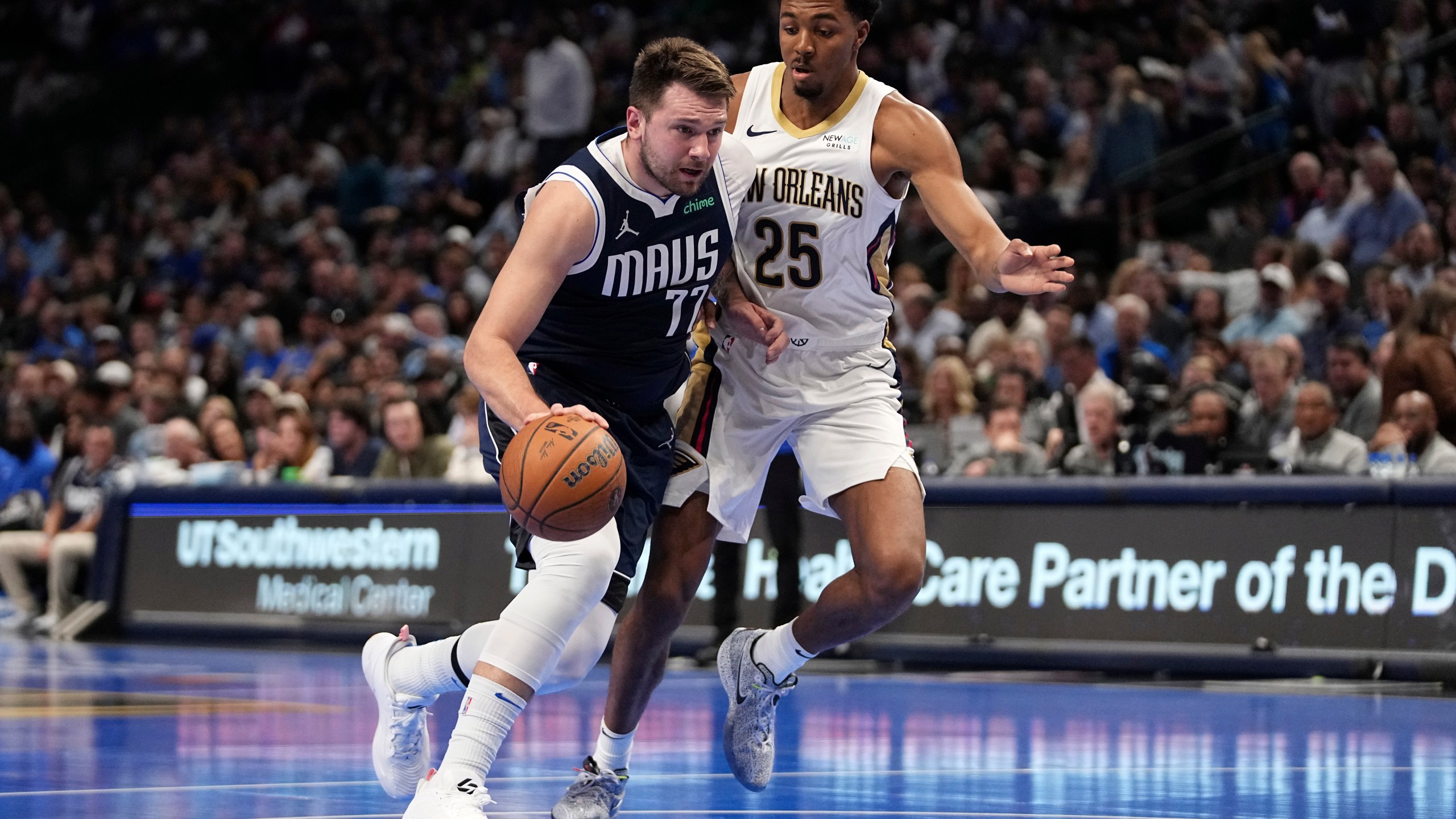 Dallas Mavericks guard Luka Doncic (77) drives to the basket as New Orleans Pelicans' Trey Murphy III (25) defends in the first half of an Emirates NBA Cup basketball game in Dallas, Tuesday, Nov. 19, 2024. (AP Photo/Tony Gutierrez)