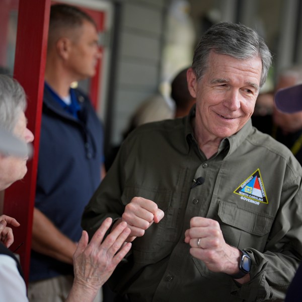 FILE - North Carolina Gov. Roy Cooper greets people, Oct. 3, 2024, in Boone, N.C., in the aftermath of hurricane Helene. (AP Photo/Chris Carlson, File)