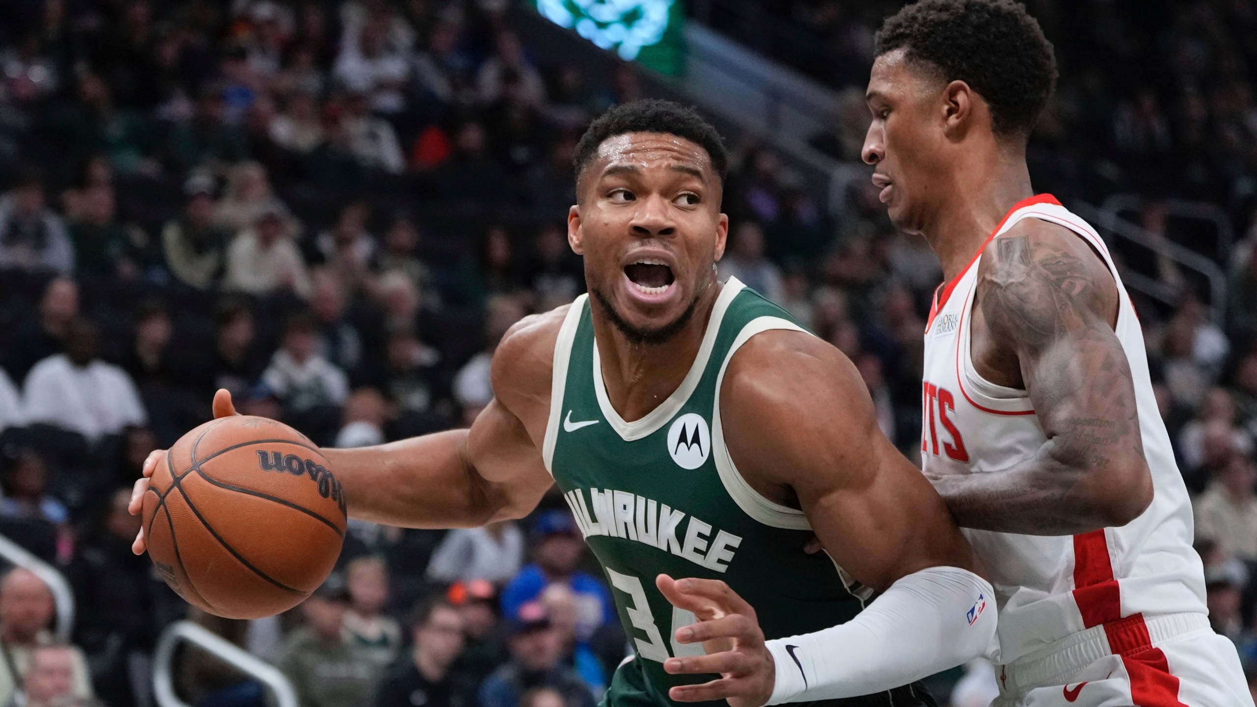 Milwaukee Bucks' Giannis Antetokounmpo tries to get past Houston Rockets' Jabari Smith Jr. during the first half of an NBA basketball game Monday, Nov. 18, 2024, in Milwaukee. (AP Photo/Morry Gash)