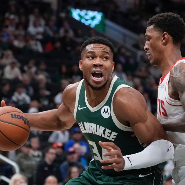 Milwaukee Bucks' Giannis Antetokounmpo tries to get past Houston Rockets' Jabari Smith Jr. during the first half of an NBA basketball game Monday, Nov. 18, 2024, in Milwaukee. (AP Photo/Morry Gash)