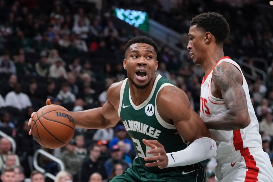 Milwaukee Bucks' Giannis Antetokounmpo tries to get past Houston Rockets' Jabari Smith Jr. during the first half of an NBA basketball game Monday, Nov. 18, 2024, in Milwaukee. (AP Photo/Morry Gash)