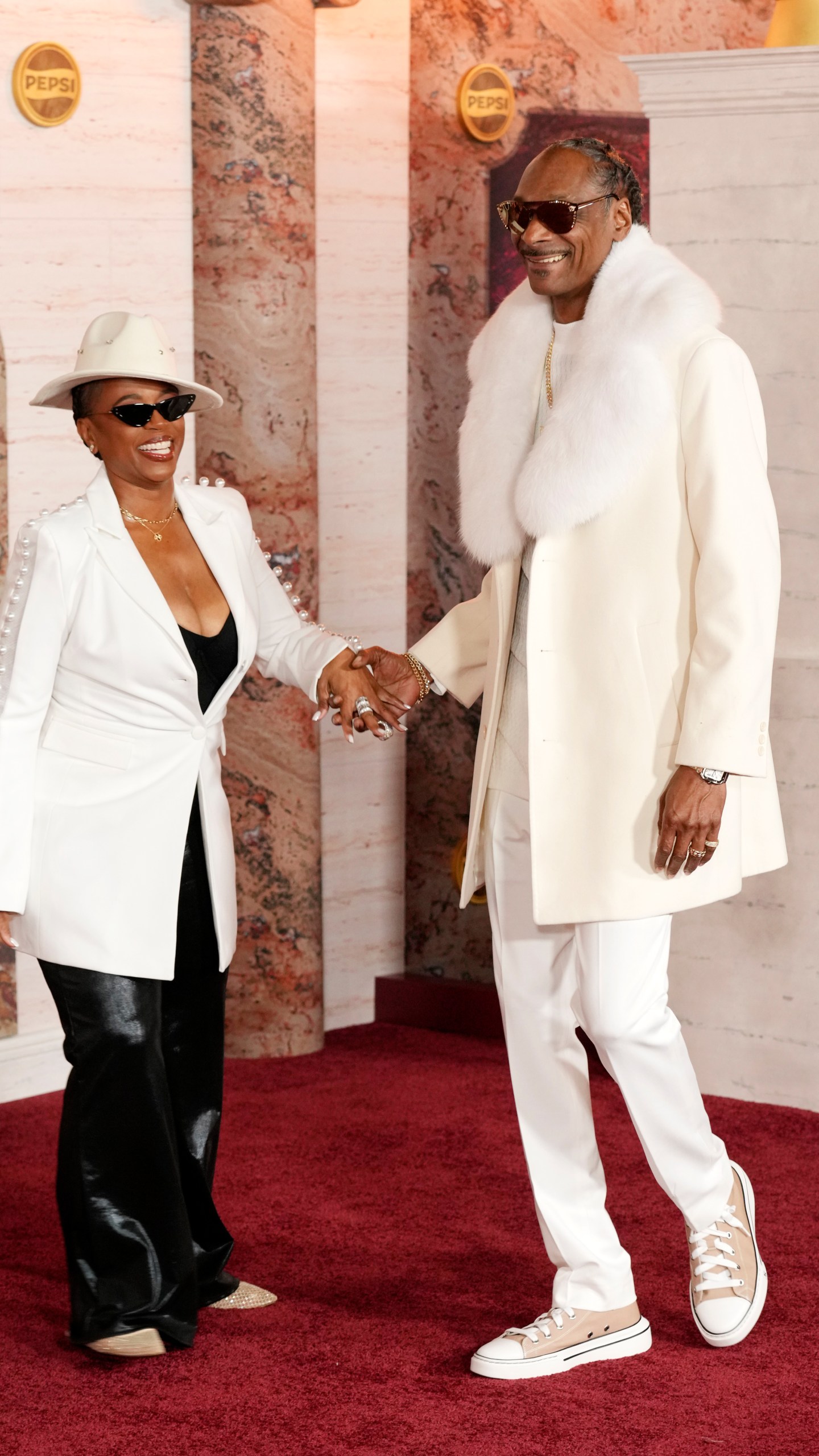 Snoop Dogg, right, and his wife Shante Broadus arrive at the premiere of the film "Gladiator II" on Monday, Nov. 18, 2024, at TCL Chinese Theatre in Los Angeles. (AP Photo/Chris Pizzello)