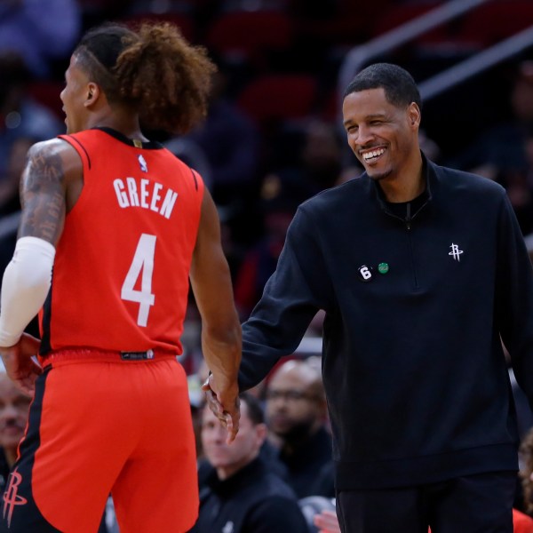 FILE - Houston Rockets guard Jalen Green (4) and head coach Stephen Silas shake hands after a score and a foul by Green against the New York Knicks during the first half of an NBA basketball game Saturday, Dec. 31, 2022, in Houston. (AP Photo/Michael Wyke, File)