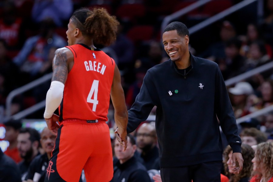 FILE - Houston Rockets guard Jalen Green (4) and head coach Stephen Silas shake hands after a score and a foul by Green against the New York Knicks during the first half of an NBA basketball game Saturday, Dec. 31, 2022, in Houston. (AP Photo/Michael Wyke, File)