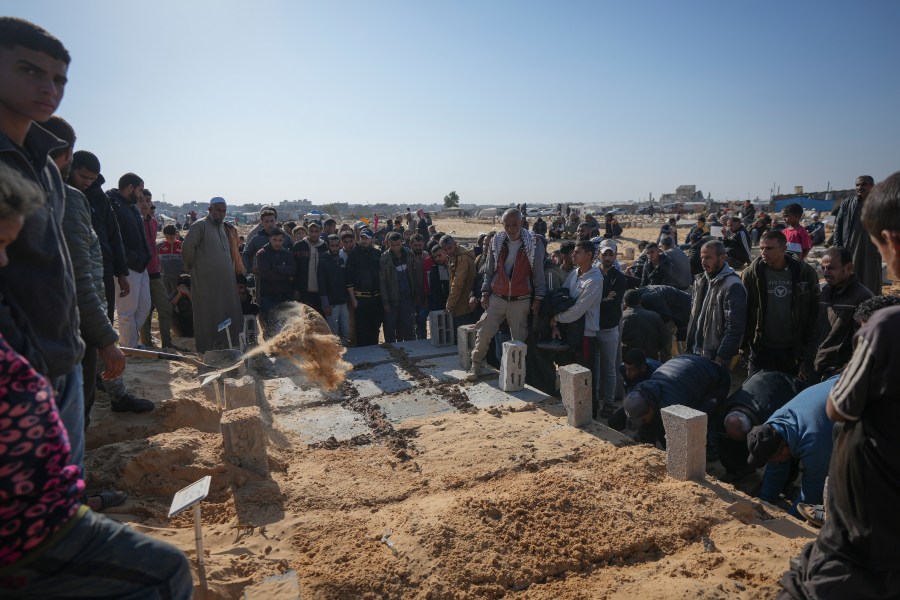 The graves of three children from the same family killed during an Israeli army strike are covered during their burial in Khan Younis, Gaza Strip, Thursday Nov. 21, 2024. Seven-year-old Hamza, his five-year-old brother Abdelaziz, and his four-year-old sister Laila Hassan were among 9 people killed by an Israeli strike in Khan Younis on Wednesday. Palestinian health officials say the death toll in the Gaza Strip from the 13-month-old war between Israel and Hamas has surpassed 44,000. (AP Photo/Abdel Kareem Hana)