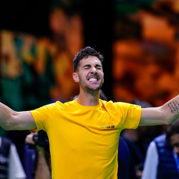 Australia's Athanasios Kokkinakis celebrates after winning against Ben Shelton of the United States during a Davis Cup quarterfinal match at the Martin Carpena Sports Hall, in Malaga, southern Spain, on Thursday, Nov. 21, 2024. (AP Photo/Manu Fernandez)