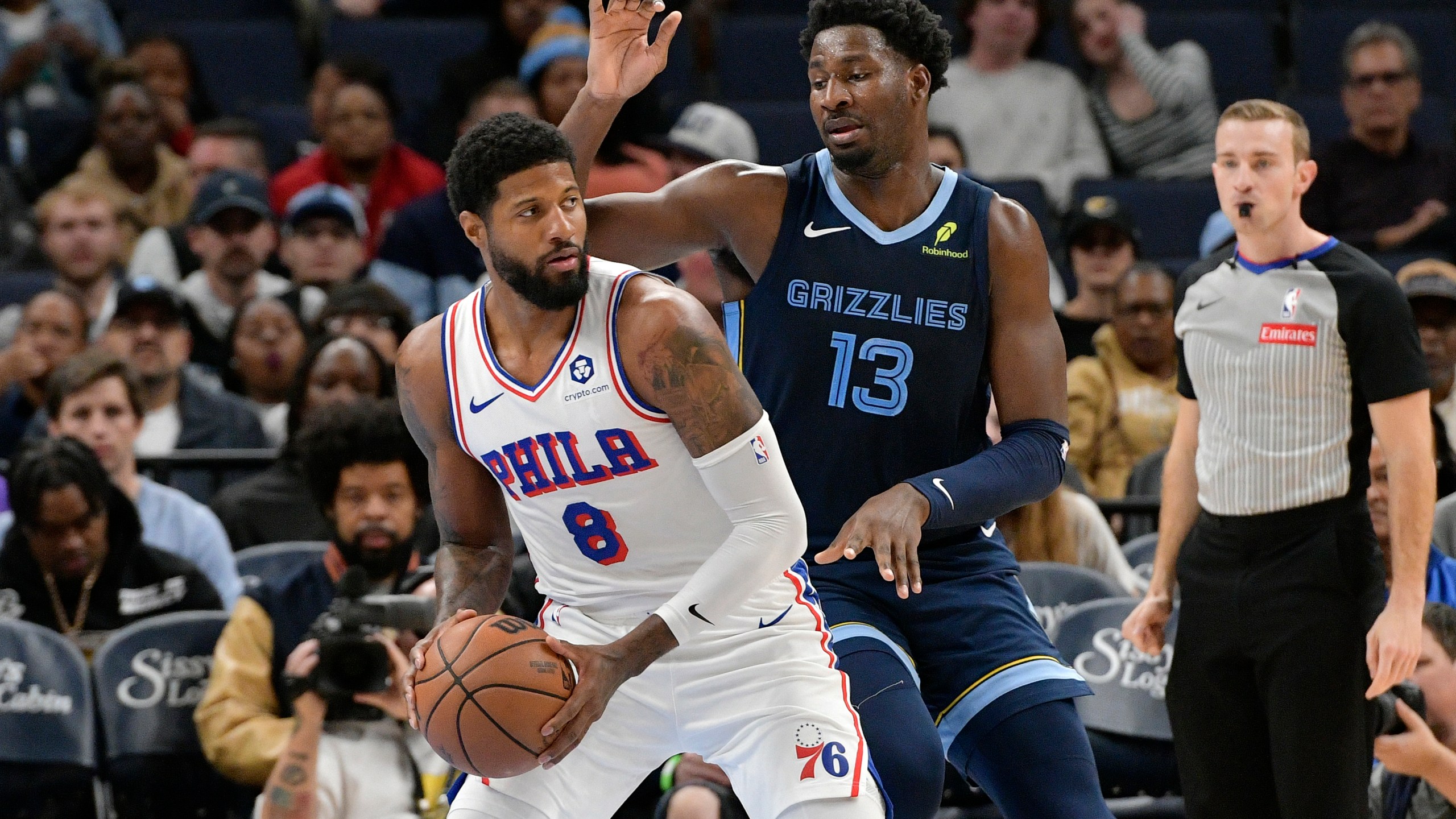 Philadelphia 76ers forward Paul George (8) handles the ball against Memphis Grizzlies forward Jaren Jackson Jr. (13) in the first half of an NBA basketball game Wednesday, Nov. 20, 2024, in Memphis, Tenn. (AP Photo/Brandon Dill)