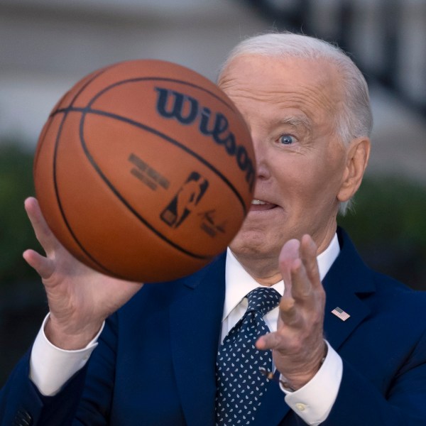 President Joe Biden throws a basketball he received from the Boston Celtics at an event to celebrate the team's victory in the 2024 National Basketball Association Championship, on the South Lawn of the White House in Washington, Thursday, Nov. 21, 2024. (AP Photo/Ben Curtis)