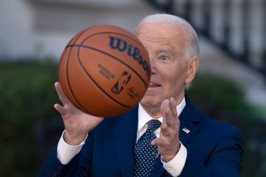 President Joe Biden throws a basketball he received from the Boston Celtics at an event to celebrate the team's victory in the 2024 National Basketball Association Championship, on the South Lawn of the White House in Washington, Thursday, Nov. 21, 2024. (AP Photo/Ben Curtis)