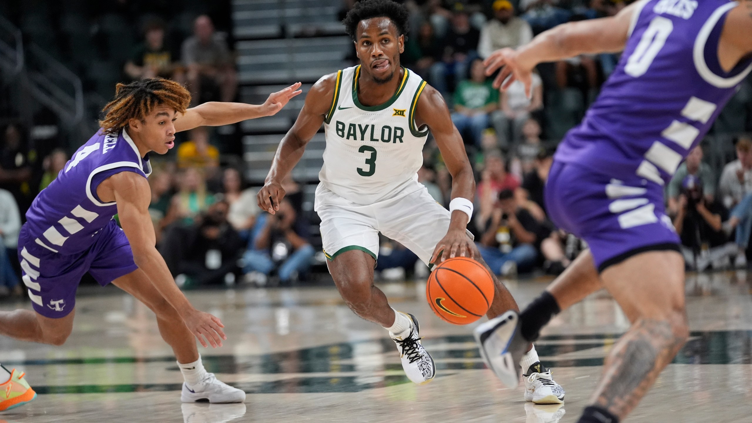 Baylor guard Jeremy Roach (3) dribbles against Tarleton State guards Jordan Mizell (4) and Izzy Miles (0) during the first half of an NCAA college basketball game, Sunday, Nov. 17, 2024, in Waco, Texas. (AP Photo/LM Otero)