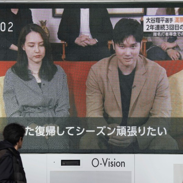 A huge screen in Osaka, western Japan shows a news report on Los Angeles Dodgers' Shohei Ohtani winning his third Most Valuable Player award, Friday, Nov. 22, 2024. (Kyodo News via AP)