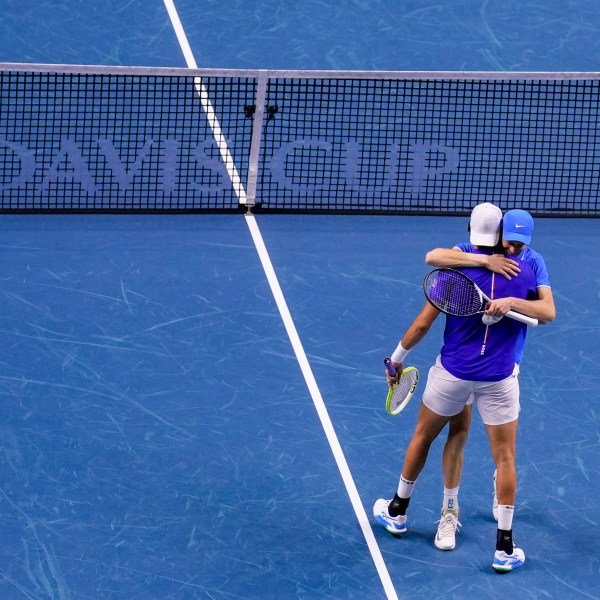 Italy's Jannik Sinner and Matteo Berrettini celebrate their victory against Argentina's Maximo Gonzalez and Andres Molteni during their doubles tennis quarterfinal Davis Cup match at the Martin Carpena Sports Hall in Malaga, southern Spain, on Thursday, Nov. 21, 2024. (AP Photo/Manu Fernandez)