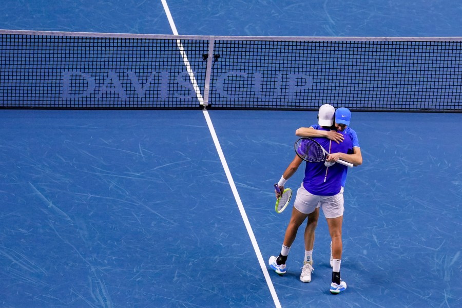 Italy's Jannik Sinner and Matteo Berrettini celebrate their victory against Argentina's Maximo Gonzalez and Andres Molteni during their doubles tennis quarterfinal Davis Cup match at the Martin Carpena Sports Hall in Malaga, southern Spain, on Thursday, Nov. 21, 2024. (AP Photo/Manu Fernandez)