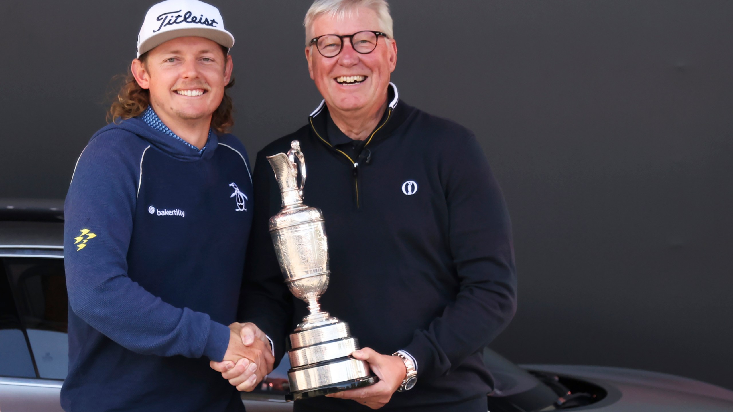 FILE - Martin Slumbers, the Chief Executive of The R&A and Secretary of The Royal and Ancient Golf Club St Andrews, with the Claret Jug trophy, and Australia's Cameron Smith, winner of the 2022 British Open, shake hands at the Royal Liverpool Golf Club in Hoylake, England, on July 17, 2023. (AP Photo/Peter Morrison, File)