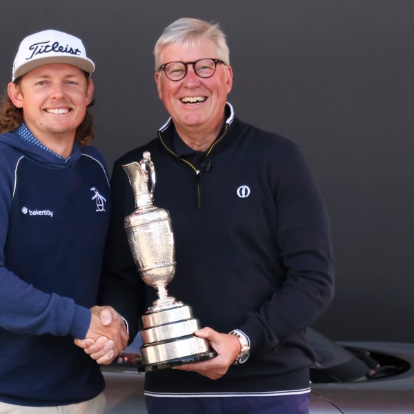 FILE - Martin Slumbers, the Chief Executive of The R&A and Secretary of The Royal and Ancient Golf Club St Andrews, with the Claret Jug trophy, and Australia's Cameron Smith, winner of the 2022 British Open, shake hands at the Royal Liverpool Golf Club in Hoylake, England, on July 17, 2023. (AP Photo/Peter Morrison, File)