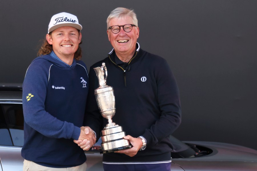 FILE - Martin Slumbers, the Chief Executive of The R&A and Secretary of The Royal and Ancient Golf Club St Andrews, with the Claret Jug trophy, and Australia's Cameron Smith, winner of the 2022 British Open, shake hands at the Royal Liverpool Golf Club in Hoylake, England, on July 17, 2023. (AP Photo/Peter Morrison, File)