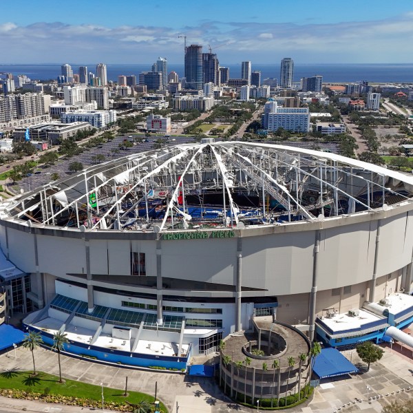 FILE - The roof of the Tropicana Field is damaged the morning after Hurricane Milton hit the region, Oct. 10, 2024, in St. Petersburg, Fla. (AP Photo/Mike Carlson, File)