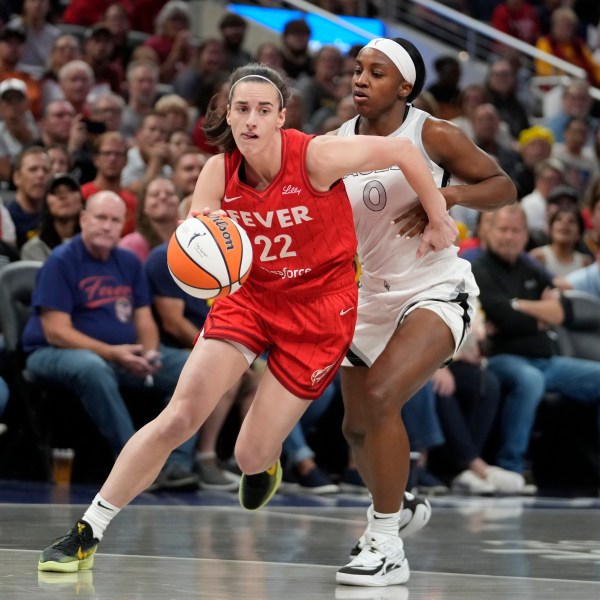 FILE - Indiana Fever's Caitlin Clark (22) goes to the basket against Las Vegas Aces' Jackie Young (0) during the first half of a WNBA basketball game, Sept. 11, 2024, in Indianapolis. (AP Photo/Darron Cummings, File)