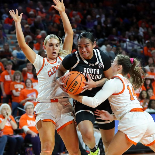 South Carolina guard Te-Hina Paopao, center, drives past Clemson guard Hannah Kohn, left, and guard Addie Porter (14) during the first half of an NCAA college basketball game Wednesday, Nov. 20, 2024, in Clemson, S.C. (AP Photo/Artie Walker Jr.)