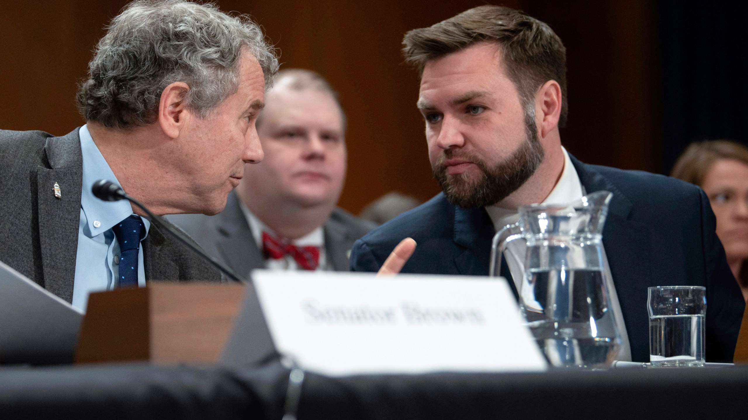 FILE - Sen. JD Vance, R-Ohio, right, speaks with Sen. Sherrod Brown, D-Ohio, before testifying at a hearing, March 9, 2023, in Washington. (AP Photo/Kevin Wolf, File)